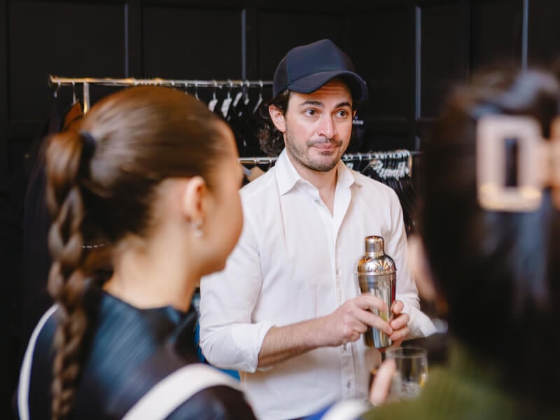 Students listening to their teacher at a cocktail making class